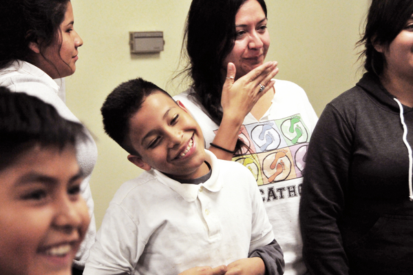 Victor Perez, center, and mentor Anna Camberos smile as the next round of the the “Titanic” friendship game is called out at the Silver Star Resource Center in Salinas.