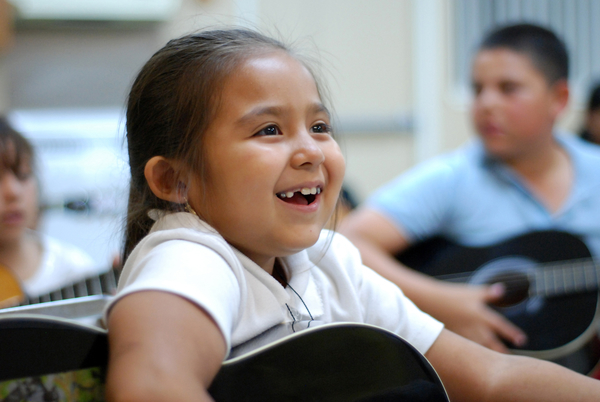 Liz Santoyo, 7, really enjoys Felix Miranda's open guitar class at CHISPA's Roosevelt Townhomes in Salinas.