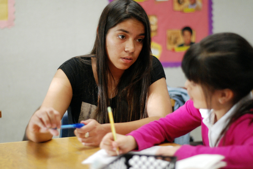 Tutor Mariana Garcia, left, works with student Miranda Escobar on her homework at the Los Padres Learning Center in Salinas.