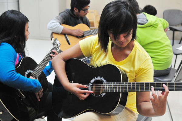 Rosa Rondin, 15, practices at Felix Miranda's open guitar class at CHISPA's Roosevelt Townhomes in Salinas.