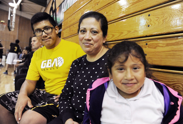 Isaac Dueñas, a 7th-grader at El Sausal Middle School, gets plenty of support from his mother, Leticia, and little sister Emily, 8.